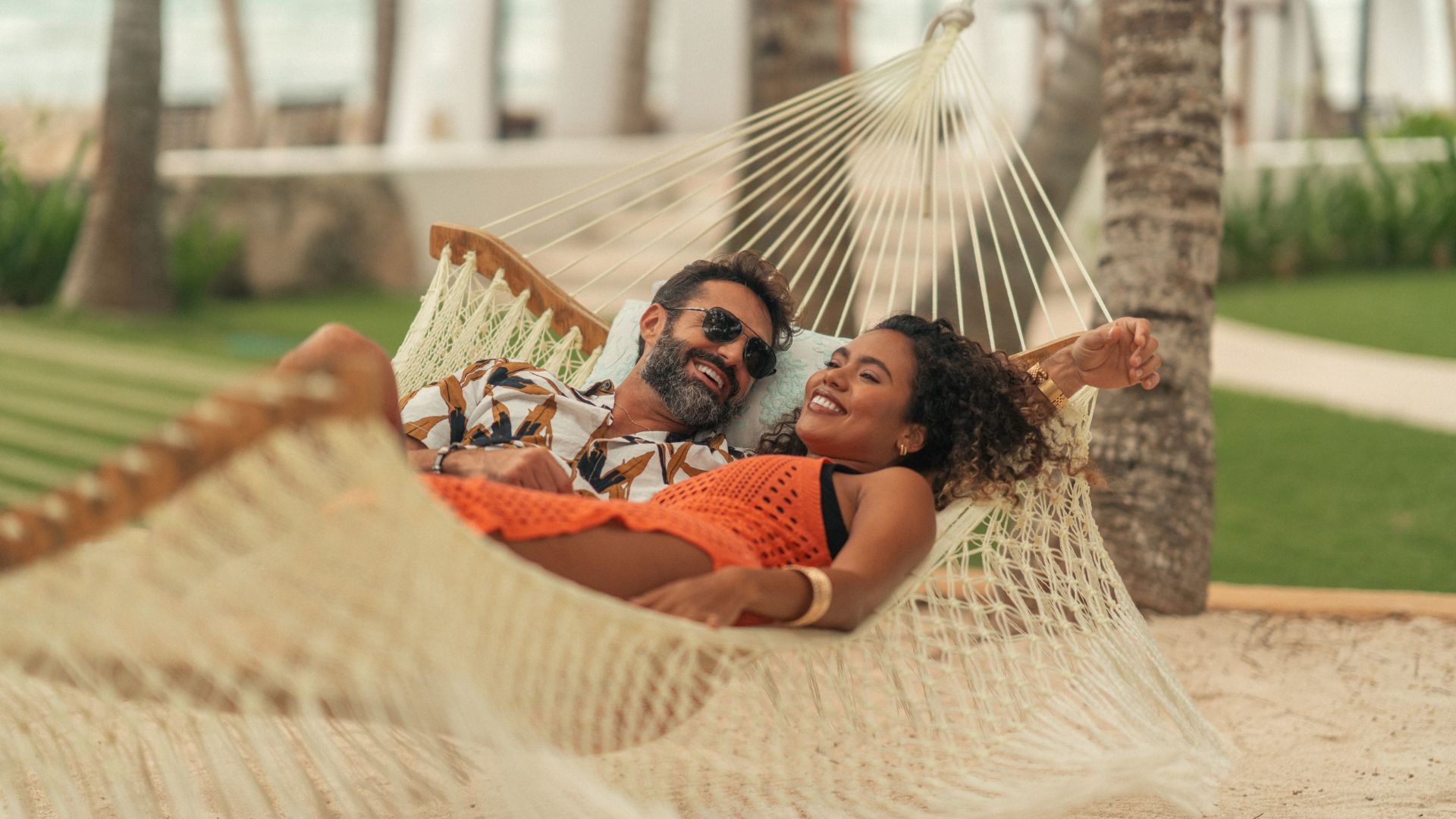 A Man And Woman Lying In A Hammock